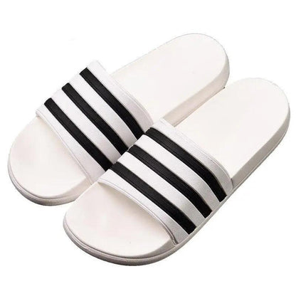 White slide sandals by Stevvex with black striped bands, casual summer outdoor footwear on Tampa Home & Garden Store