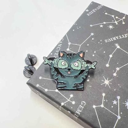 Cat enamel pin by Shaketea, teal goofy cat with wide eyes on constellation card on Tampa Home & Garden Store