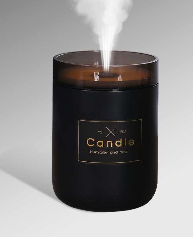 Ultrasonic candle-shaped humidifier 280ml in black with amber lid emitting mist on Tampa Home & Garden Store