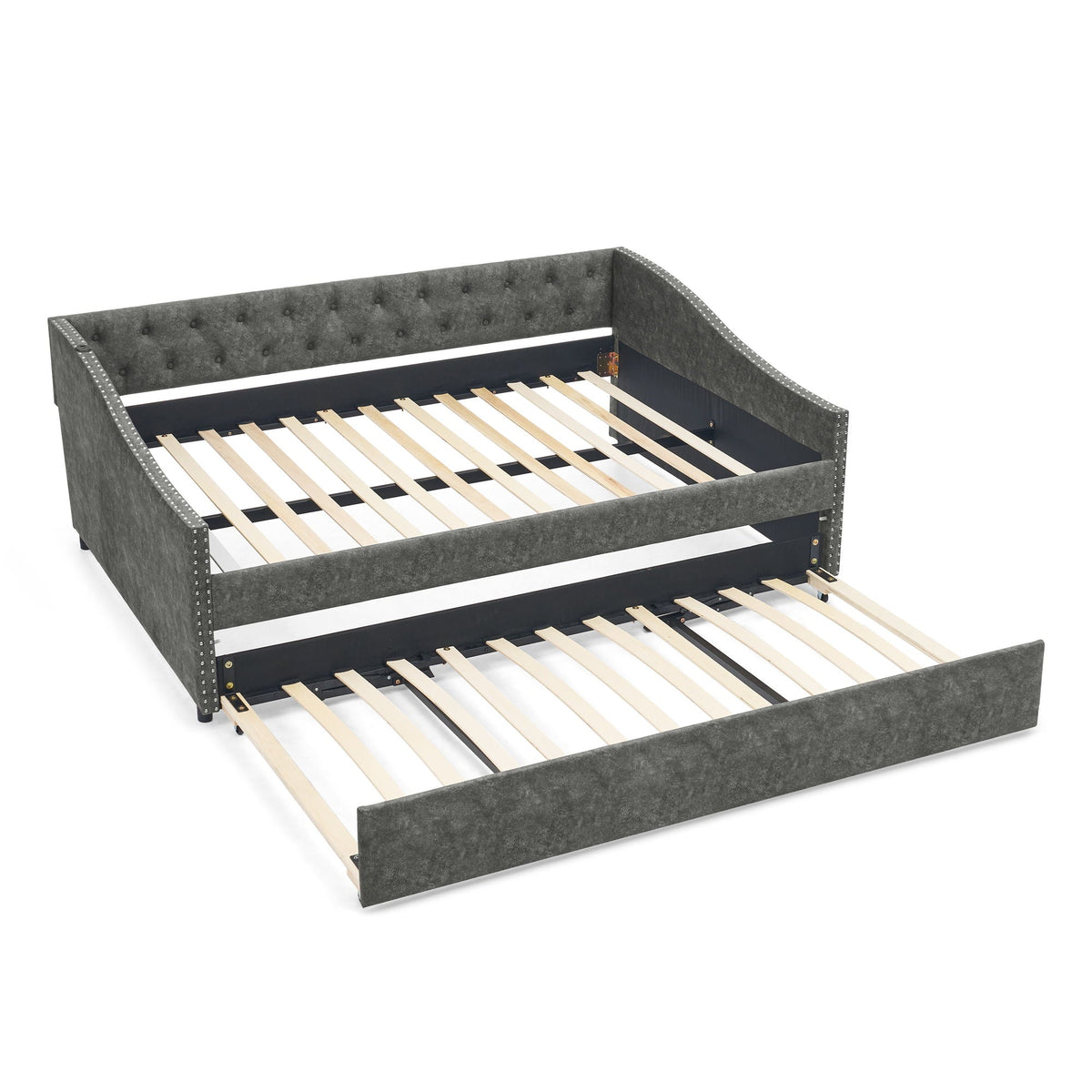 Upholstered gray daybed with tufted back and studded trim, pull-out trundle with wood slats on Tampa Home & Garden Store