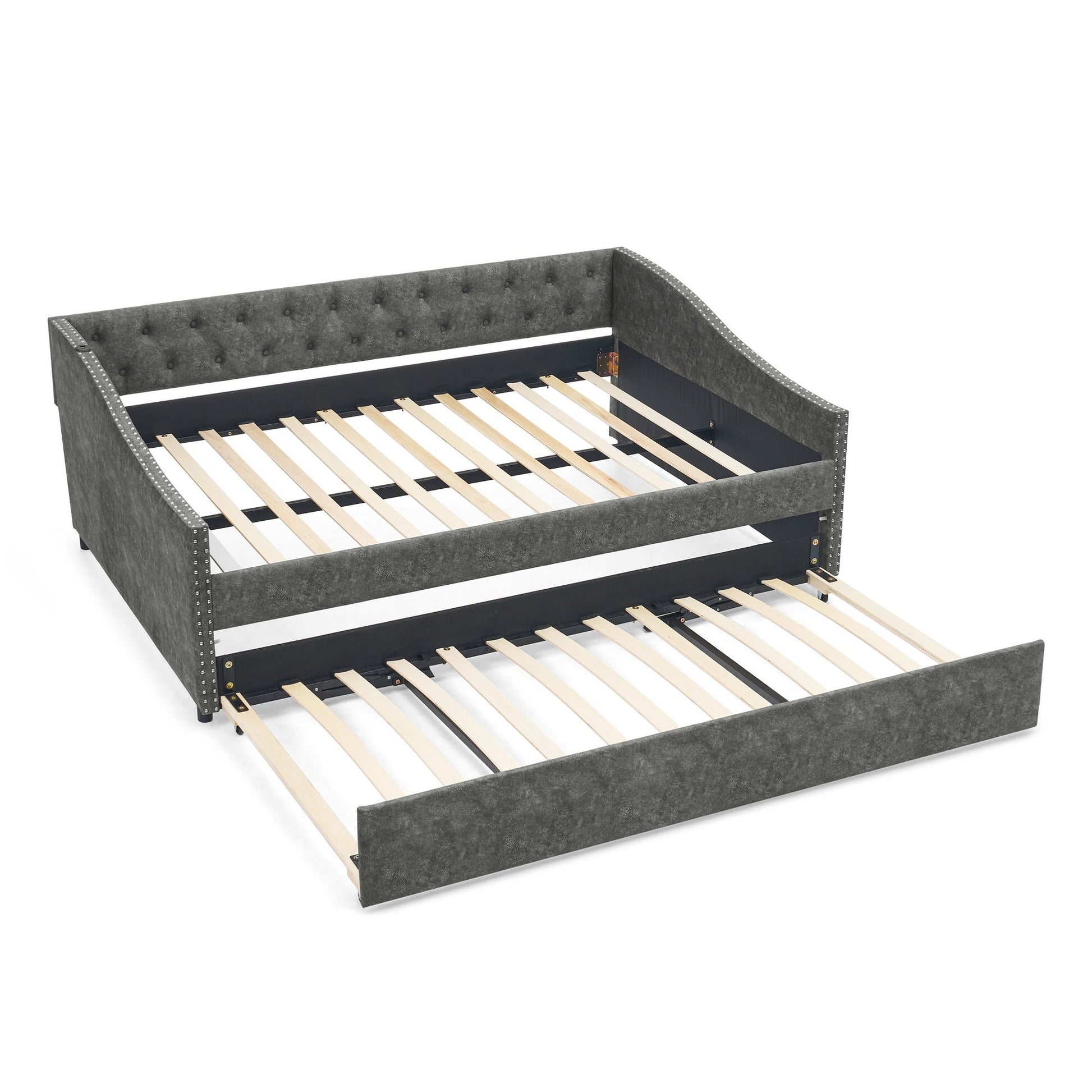 Upholstered gray daybed with tufted back and studded trim, pull-out trundle with wood slats on Tampa Home & Garden Store