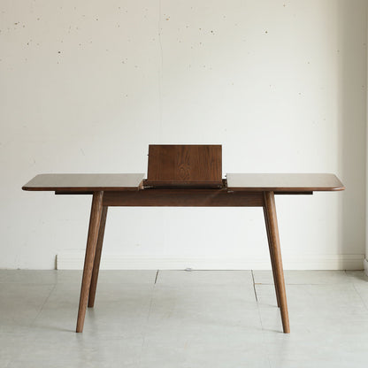 Telescopic wood dining table with extendable top in walnut finish with center leaf on Tampa Home & Garden Store