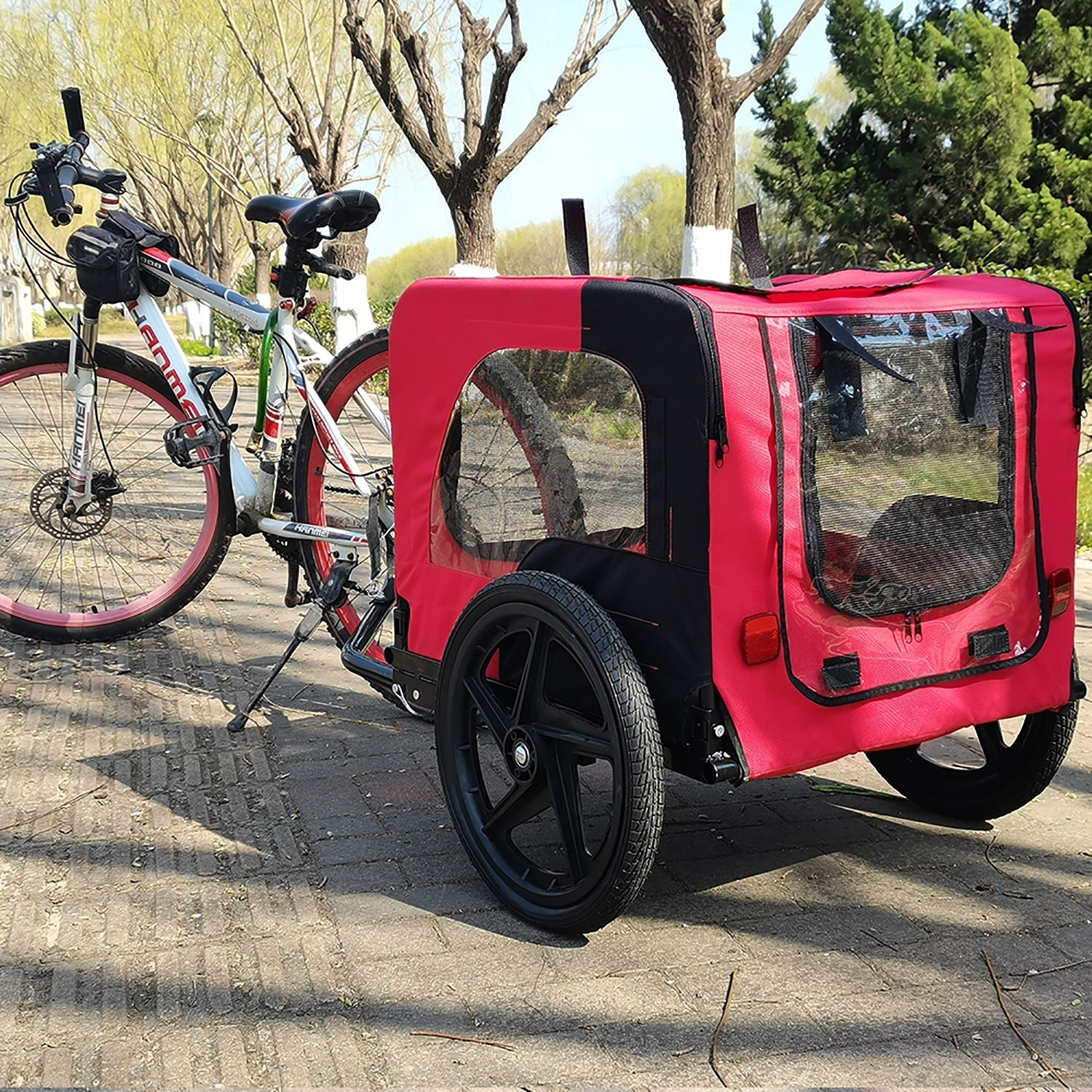 Pet bike trailer for small and medium pets, red fabric with mesh windows, attached to bike on Tampa Home & Garden Store