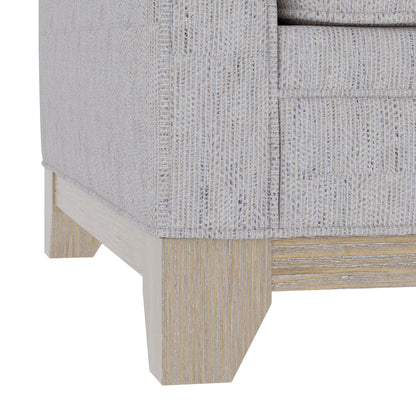 Loveseat with gray textured durable fabric close-up showing light wood legs on Tampa Home & Garden Store