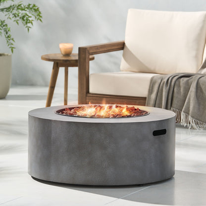 Round iron fire pit with lava rocks and glowing embers, gray metal finish 40,000 BTU on Tampa Home & Garden Store