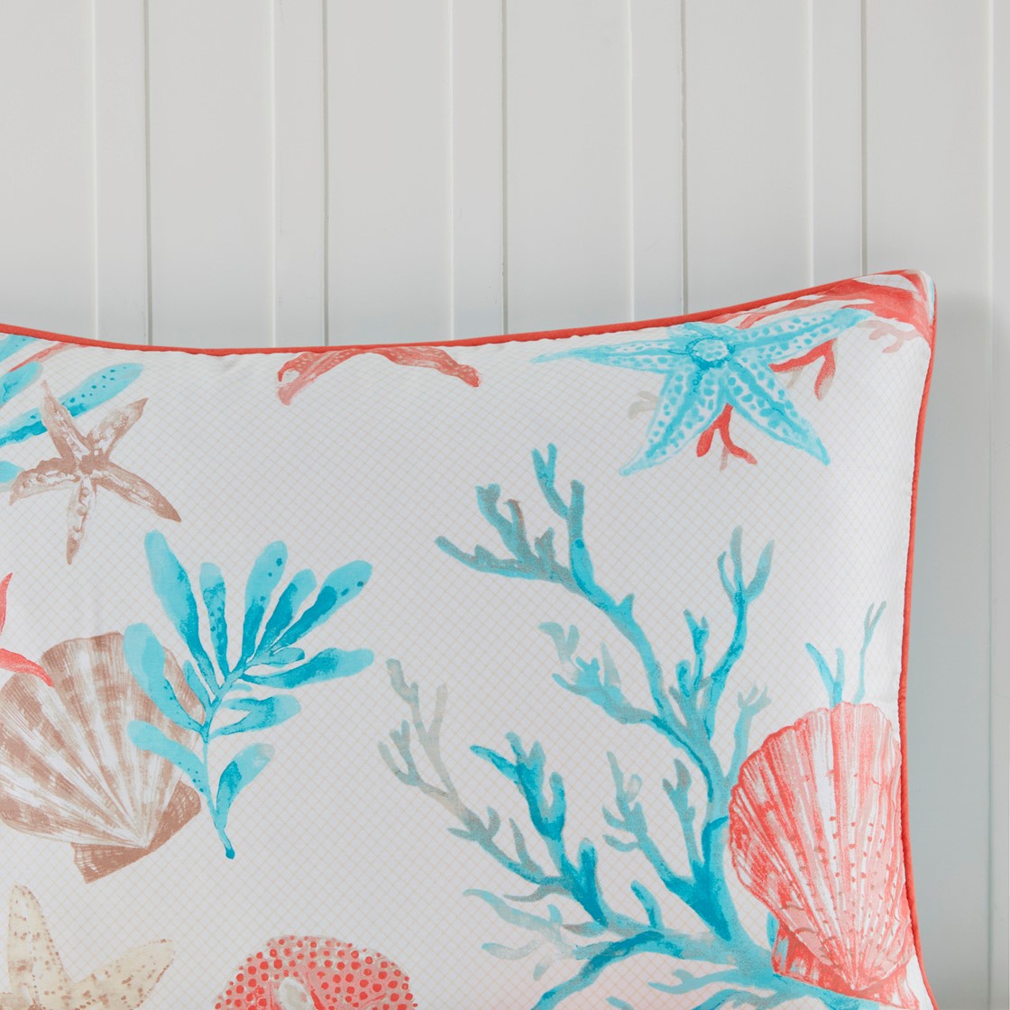 Decorative coastal pillow from HouseOfZazla with coral border and turquoise sea life print on Tampa Home & Garden Store