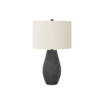 Table lamp with resin base in black and beige fabric shade on Tampa Home & Garden Store