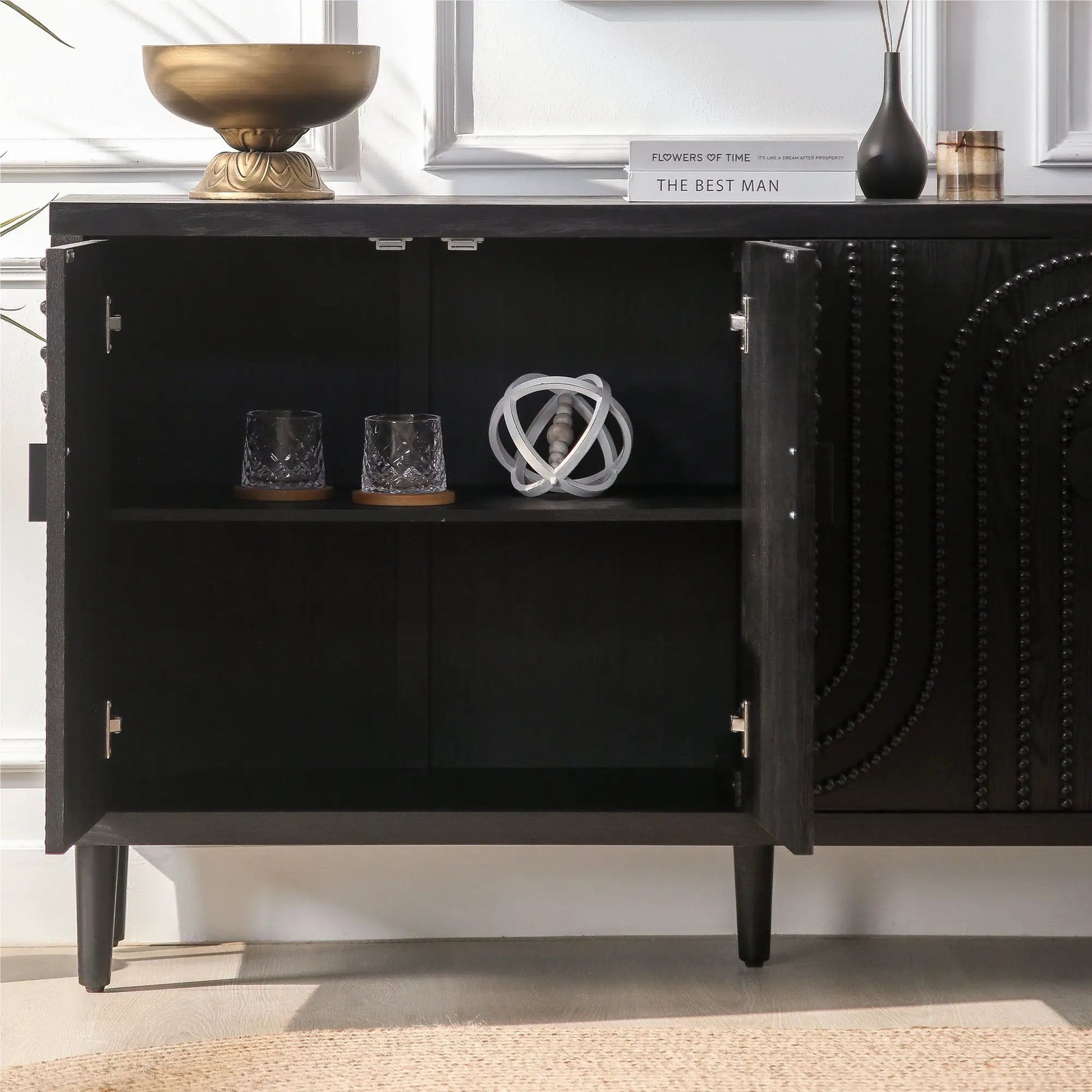 Modern black sideboard cabinet with open shelf, gold bowl, books, black vase, and glassware on Tampa Home & Garden Store
