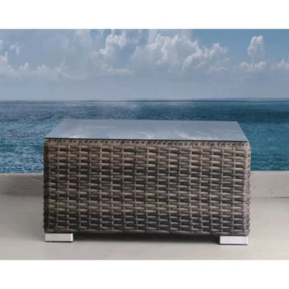 Rectangular outdoor wicker coffee table with a gray top and chrome feet on Tampa Home & Garden Store