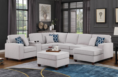 Tina 8-piece upholstered sectional with ottoman in light gray fabric, blue cushions on Tampa Home & Garden Store