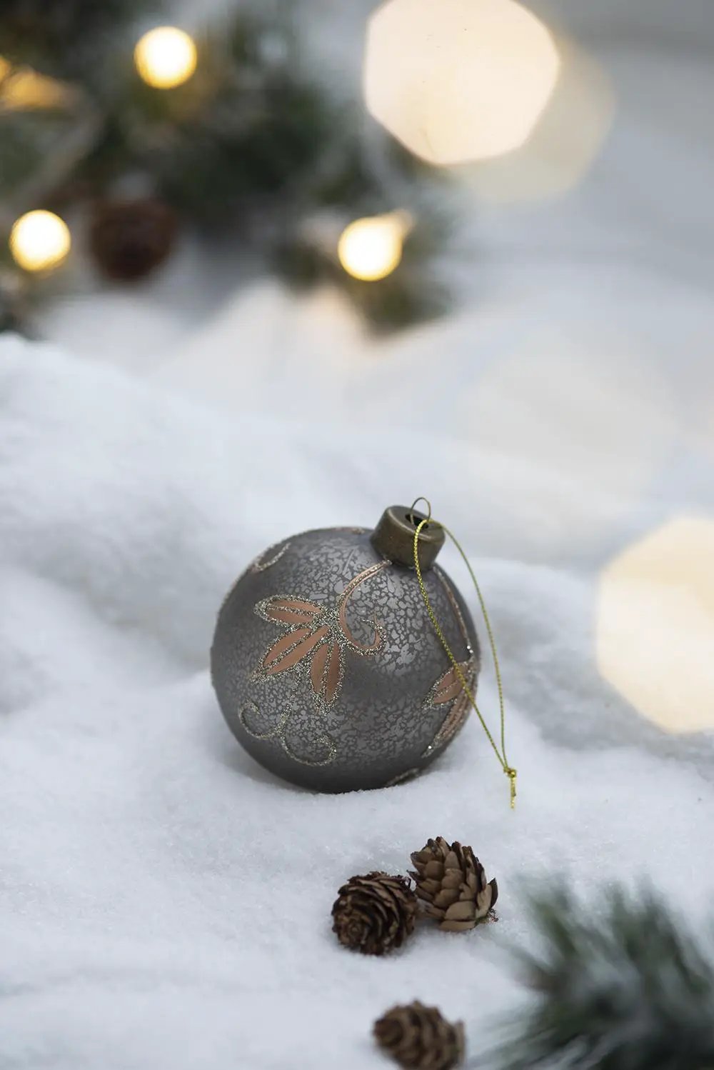 Gray matte Christmas ball ornament with copper pattern, hanging tree decor on snow on Tampa Home & Garden Store