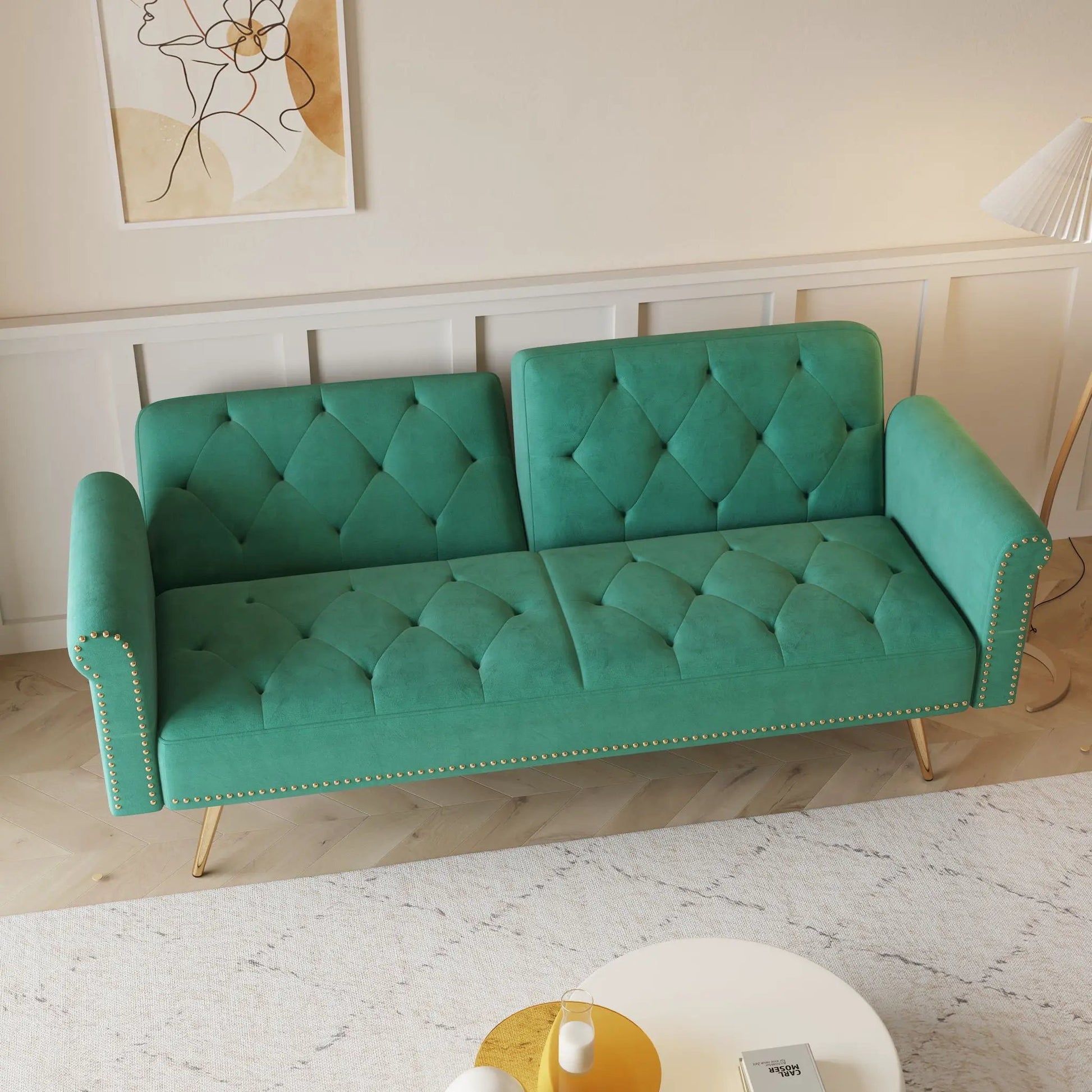 Luxurious sofa bed with nail head trim and matching pillow, two teal tufted futon sofas on Tampa Home & Garden Store