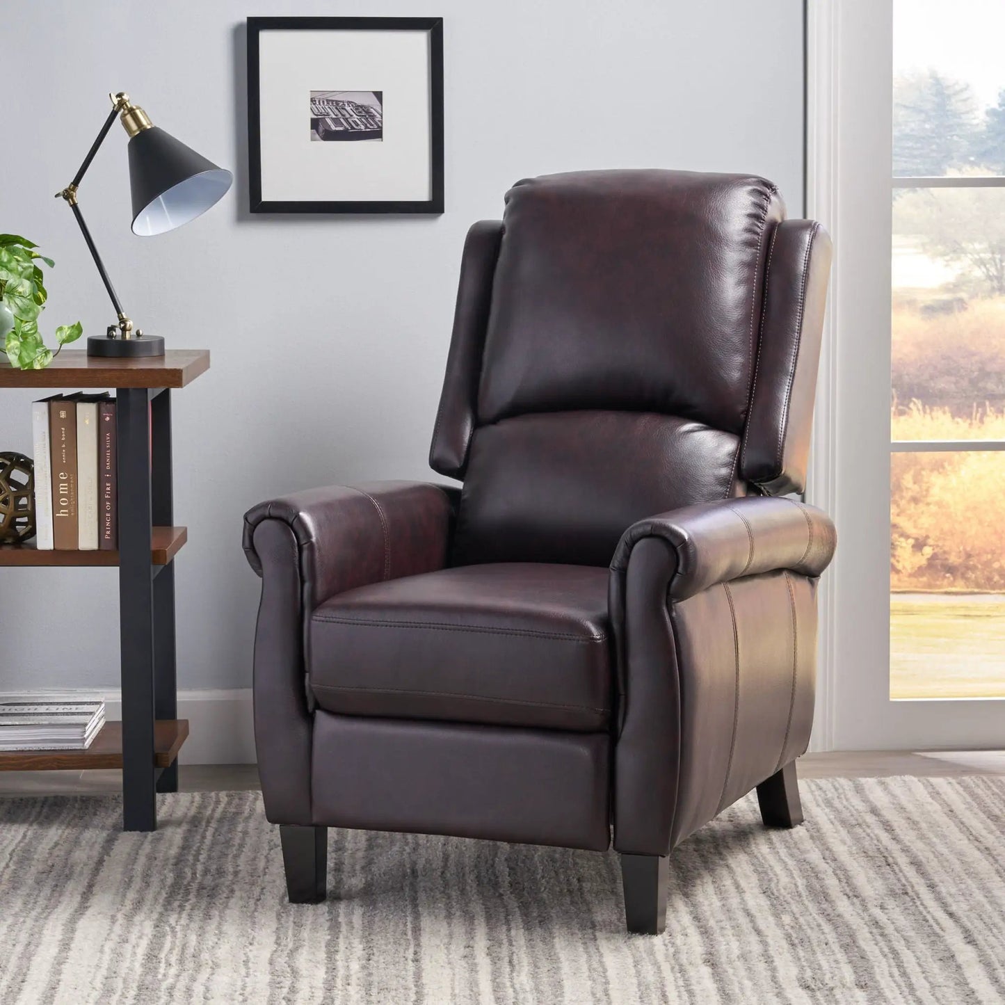 Memphis burgundy leather recliner club chair with padded arms by window on Tampa Home & Garden Store