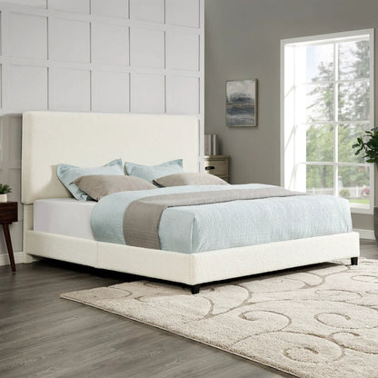 Platform bed with cream upholstered headboard and light blue bedding in a bright bedroom on Tampa Home & Garden Store