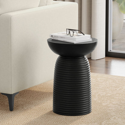 Ribbed black accent table with textured pedestal base, stacked books and glasses on Tampa Home & Garden Store