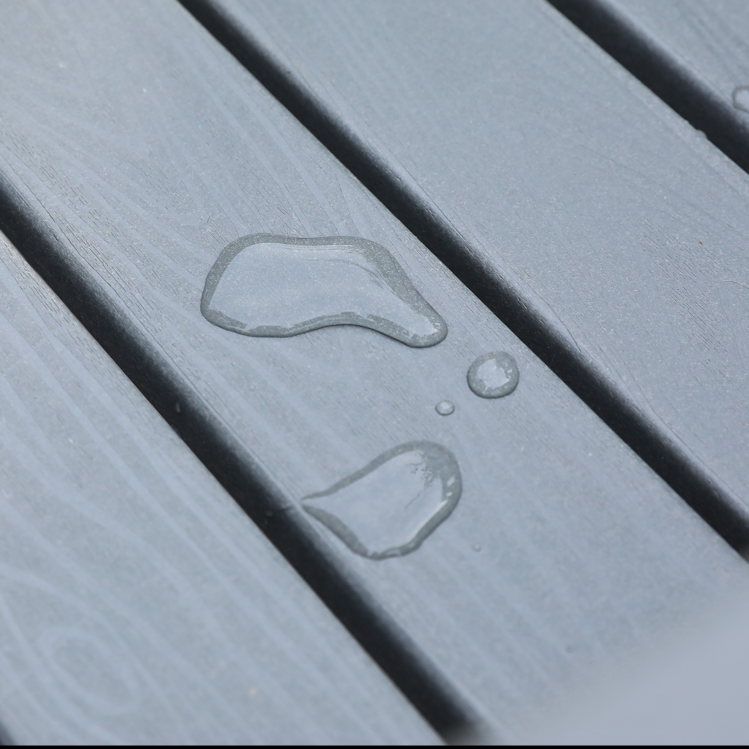 HDPE outdoor patio dining set surface with water droplets on gray deck boards on Tampa Home & Garden Store