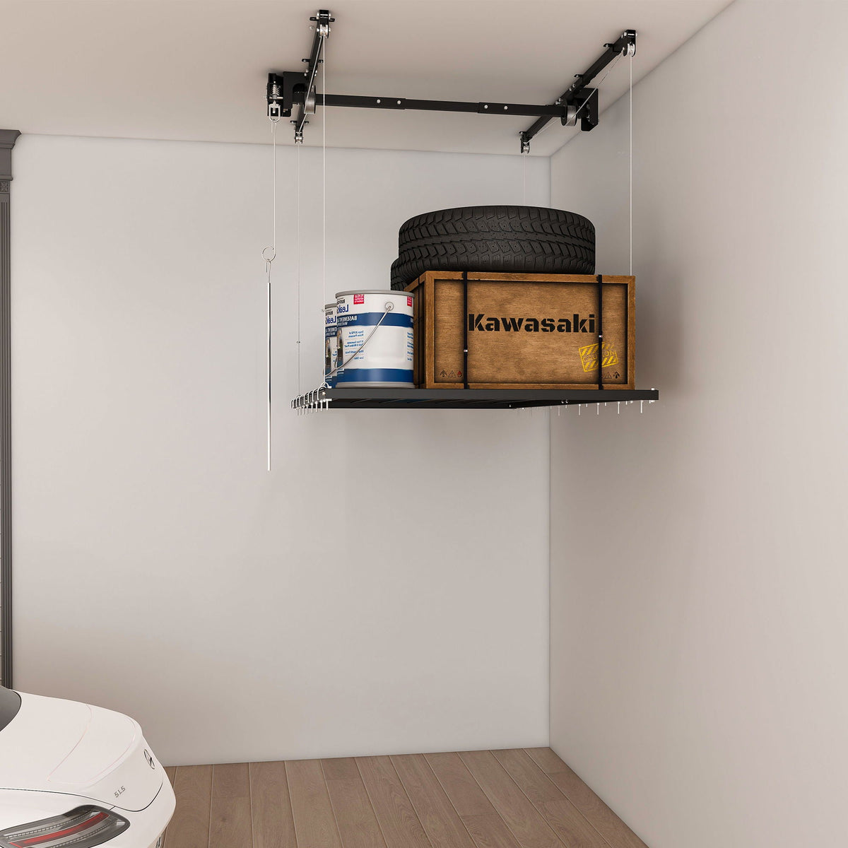 Overhead garage storage rack with crank system in black holds tire and Kawasaki crate on Tampa Home & Garden Store