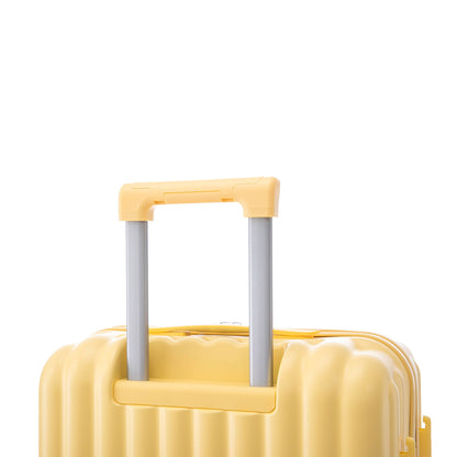 Yellow hard-shell spinner luggage with peach handle and silver telescoping rods on Tampa Home & Garden Store
