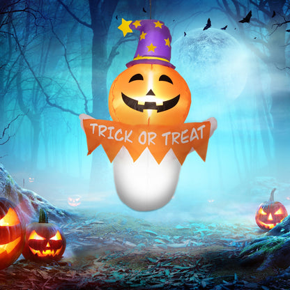 Inflatable pumpkin with glowing face, purple star hat, Trick or Treat banner in a forest on Tampa Home & Garden Store