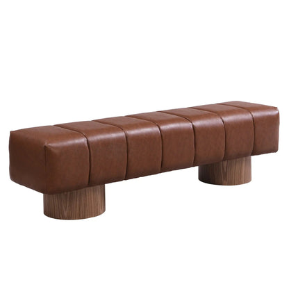 Upholstered dining bench in warm brown leather with tufted cushions and round wood legs on Tampa Home & Garden Store