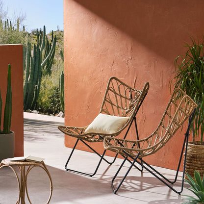 Light brown outdoor chair with geometric cross base and wicker weave, Bryson set on Tampa Home & Garden Store