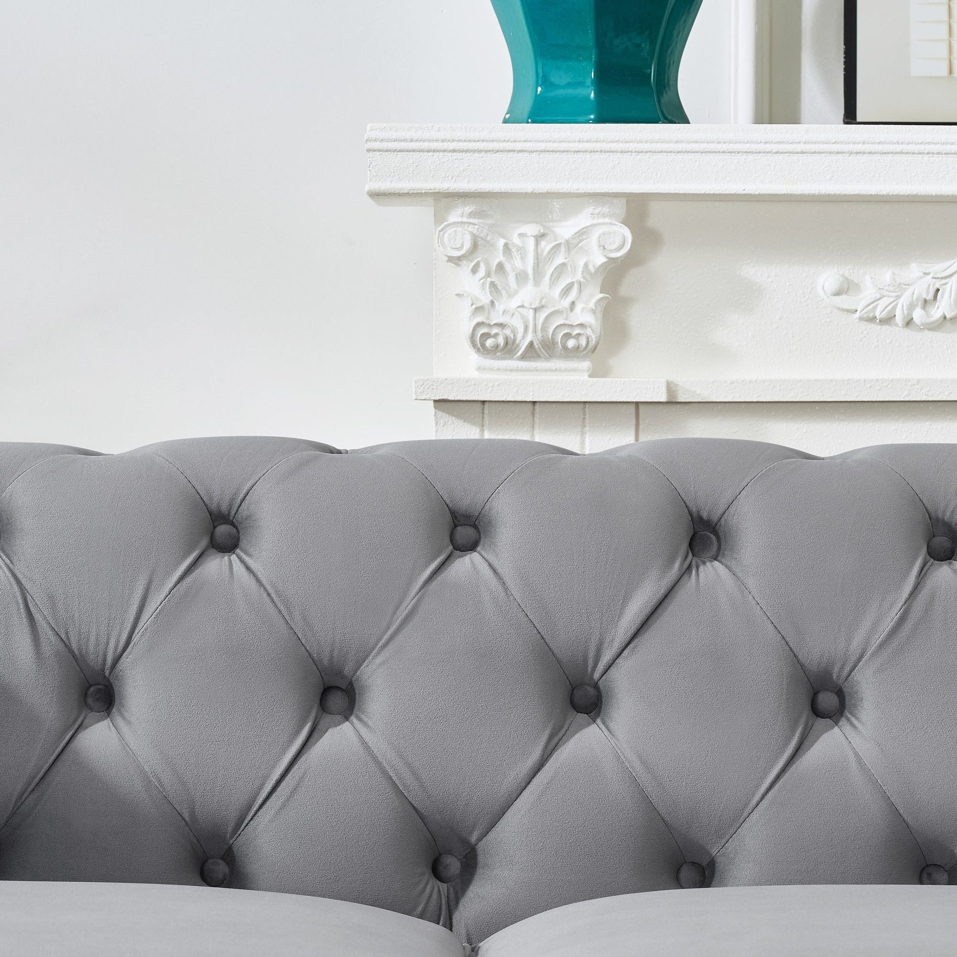 Chesterfield upholstery fabric sofa with grey tufted cushions and button-tack detailing on Tampa Home & Garden Store
