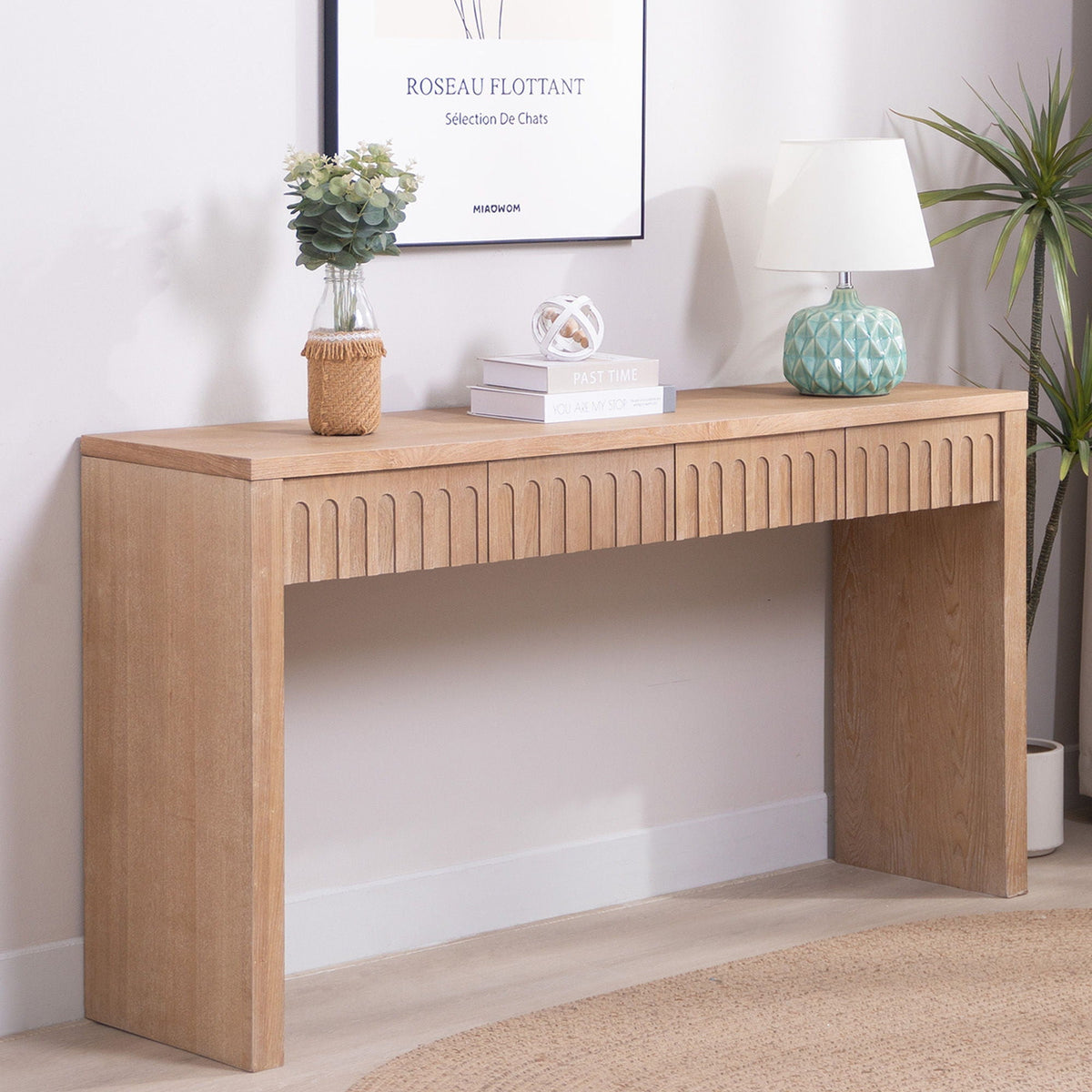 Modern console table with 4 drawers in wood finish, carved fronts, styled with books and plants on Tampa Home & Garden Store