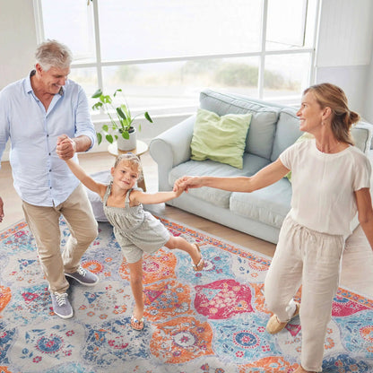 Maval area rug by Unique Piece Furniture with blue orange pink pattern in a living room on Tampa Home & Garden Store