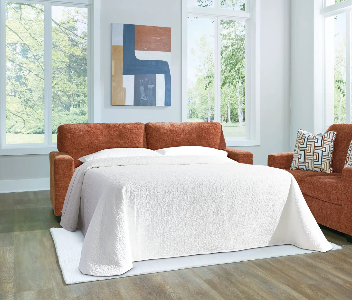 Aviemore sofa sleeper in burnt-orange fabric with a white quilted cover, modern living room on Tampa Home & Garden Store