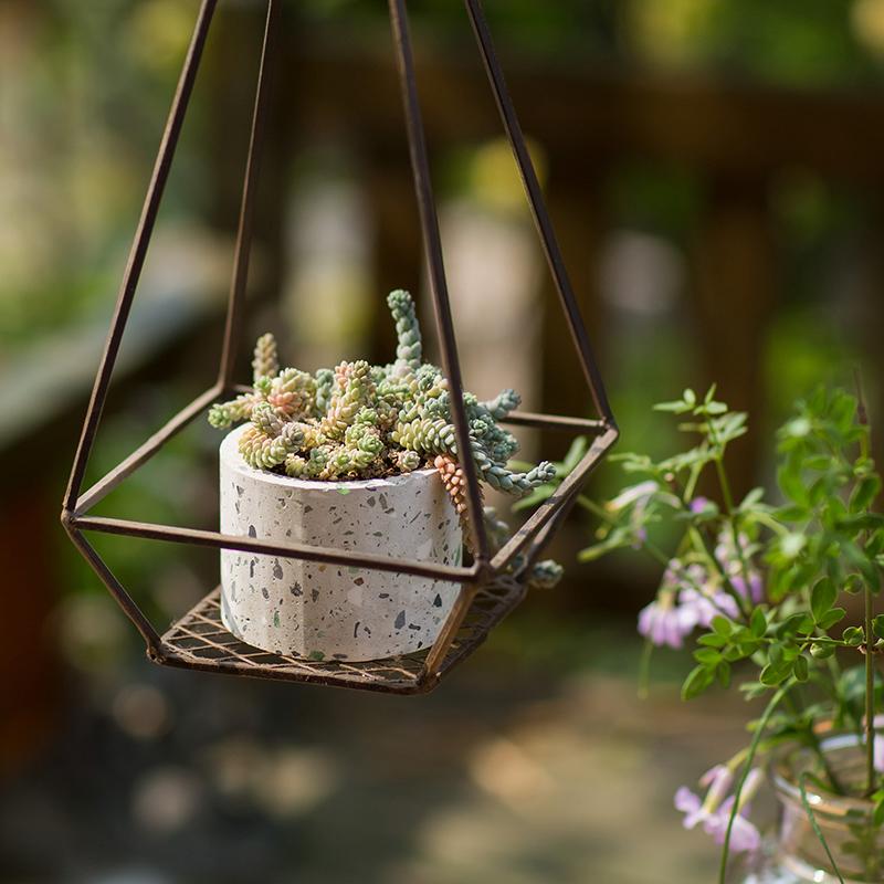 Cement planter in a speckled white pot inside a geometric hanging metal frame with succulents RusticReach on Tampa Home & Garden Store