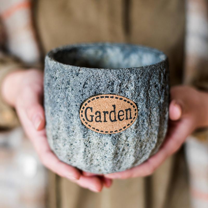 Cement Stone Tiny Garden Planter in gray textured finish with tan label held by hands on Tampa Home & Garden Store
