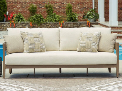 Serene Bay sofa with cushions in beige fabric and dark brown wooden frame on outdoor patio on Tampa Home & Garden Store
