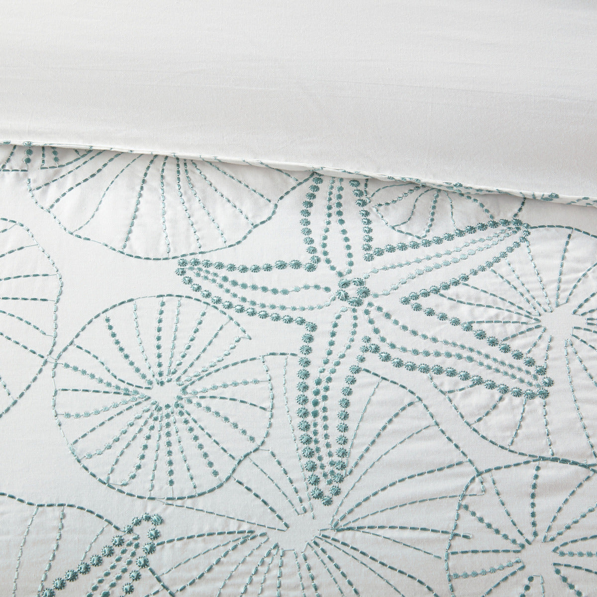 White duvet cover mini set with teal seashell embroidery on Tampa Home & Garden Store