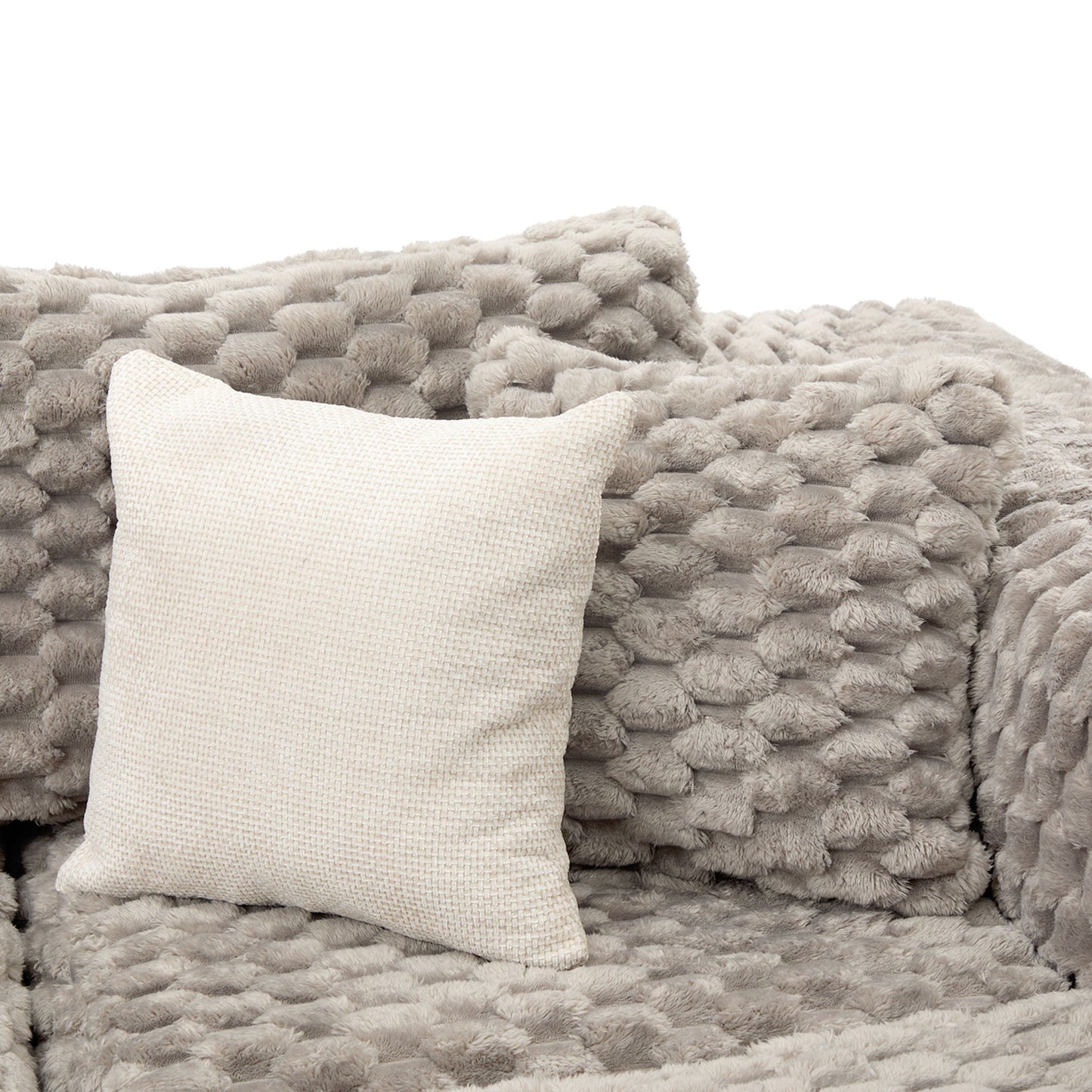 Plush gray faux-fur throw blanket with beige woven pillow on Tampa Home & Garden Store