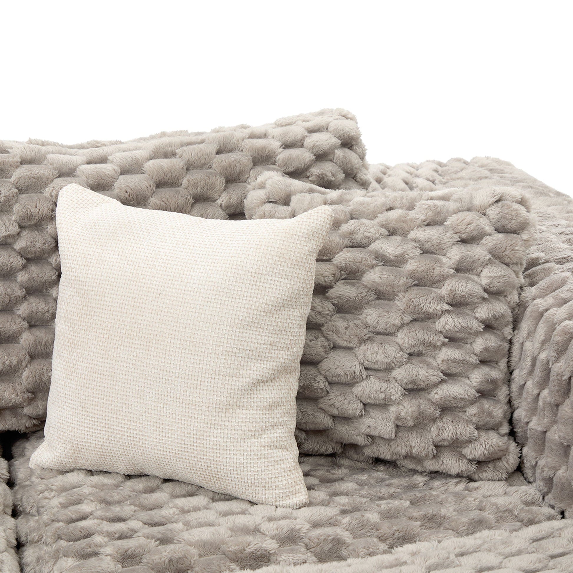 Plush gray faux-fur throw blanket with beige woven pillow on Tampa Home & Garden Store