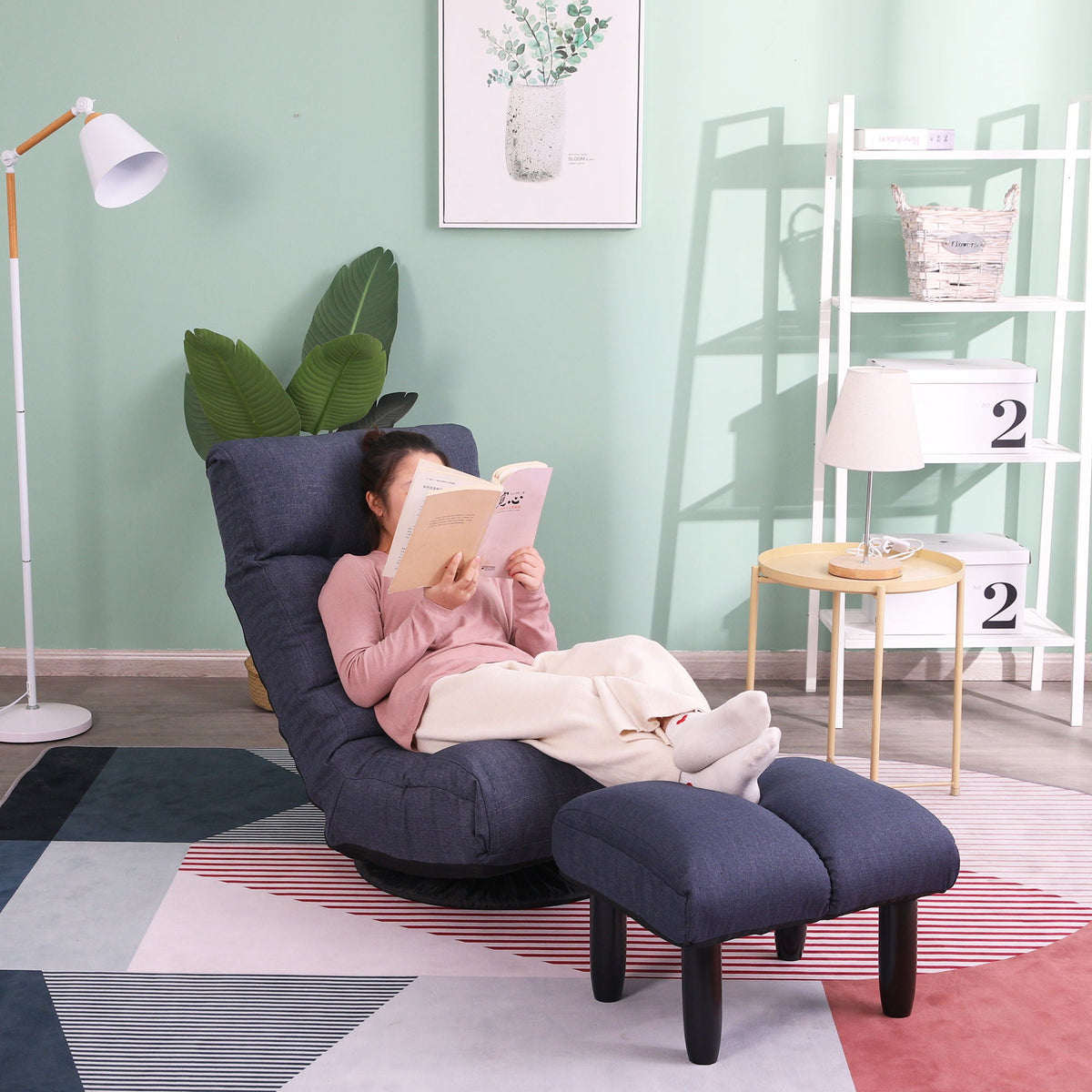 Adjustable Japanese reclining floor chair with metal frame, dark blue upholstery; reader seated on Tampa Home & Garden Store