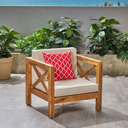 Brava mid-century outdoor arm chair with water resistant cushions and red geometric pillow on Tampa Home & Garden Store