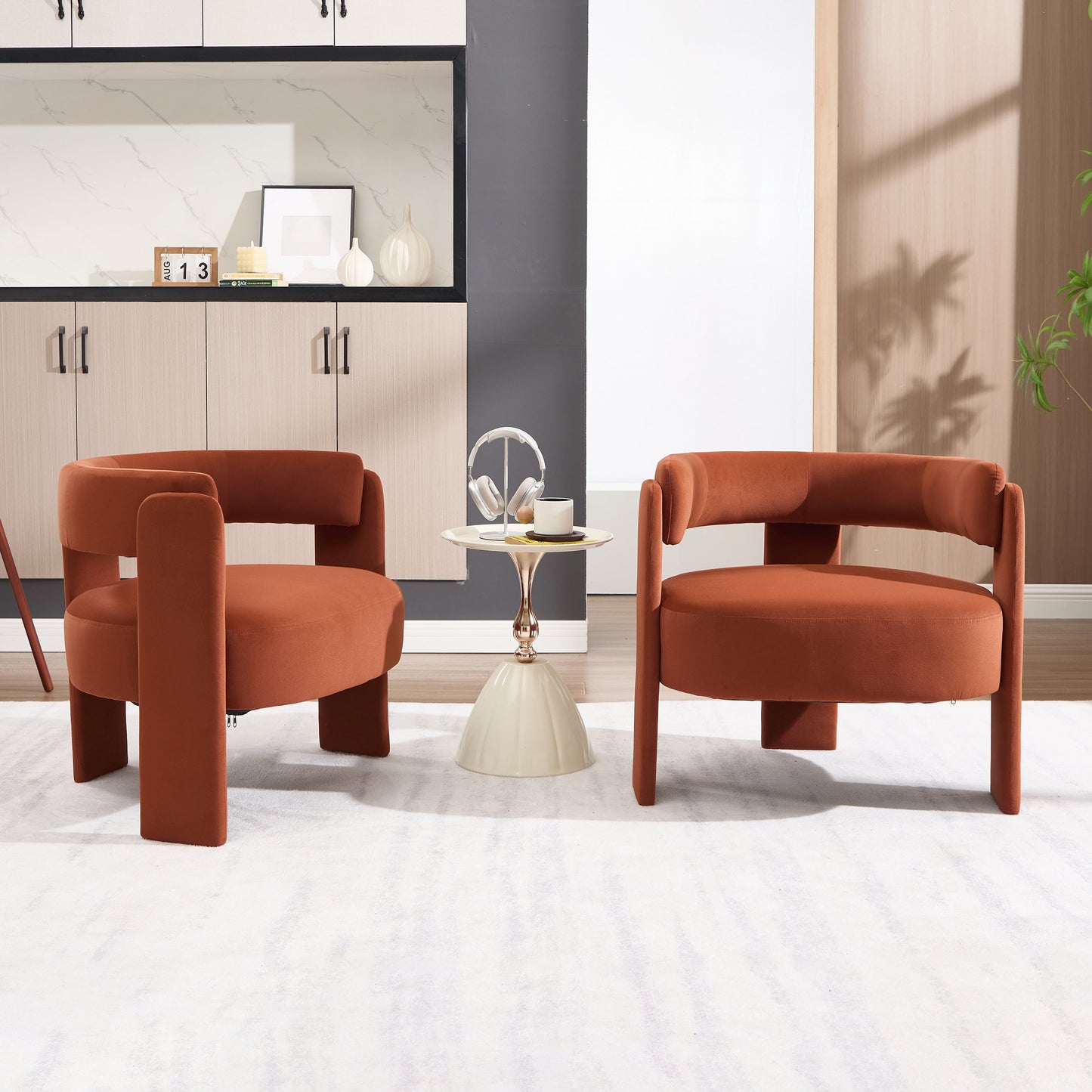 Four rust velvet accent chairs surround a round table in a modern living room on Tampa Home & Garden Store