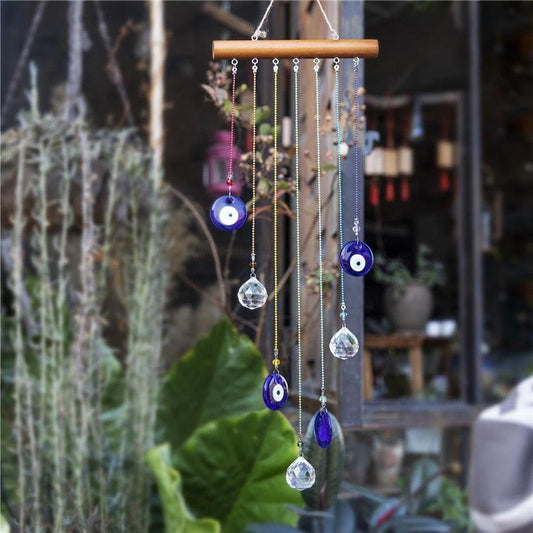 Chakra energy wind chimes with blue evil eye beads and crystal drops from a wooden bar Stevvex on Tampa Home & Garden Store