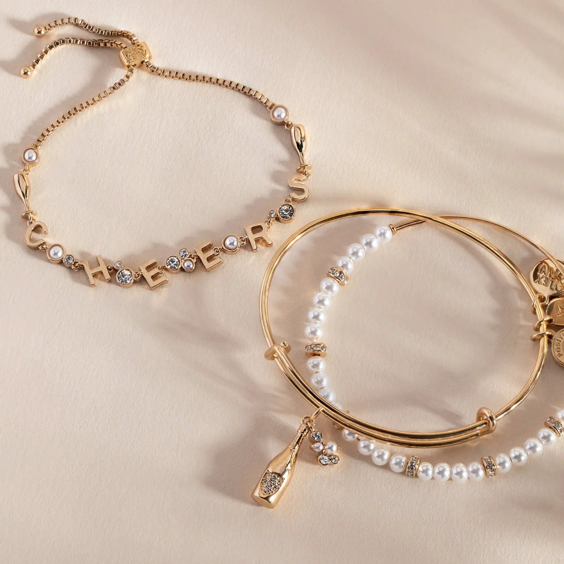 Champagne Bangle by Alex and Ani among gold-tone bracelets with pearl and crystal accents on Tampa Home & Garden Store
