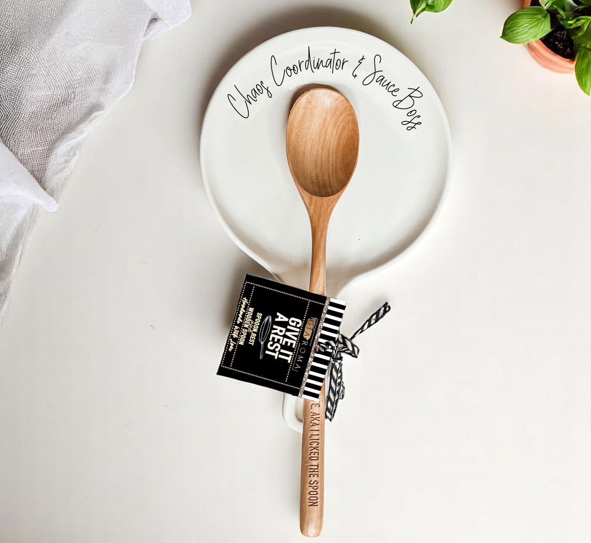 Chaos & Sauce Boss spoon rest by Gia Roma with wooden spoon on white plate on Tampa Home & Garden Store