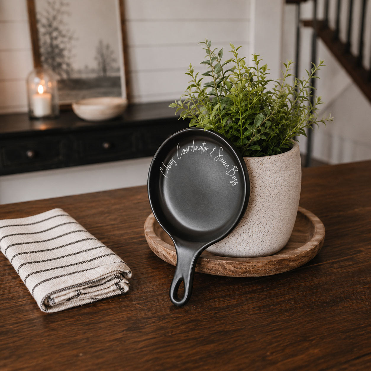 Chaos & Sauce Boss spoon rest Gia Roma black finish on kitchen counter by potted plant on Tampa Home & Garden Store