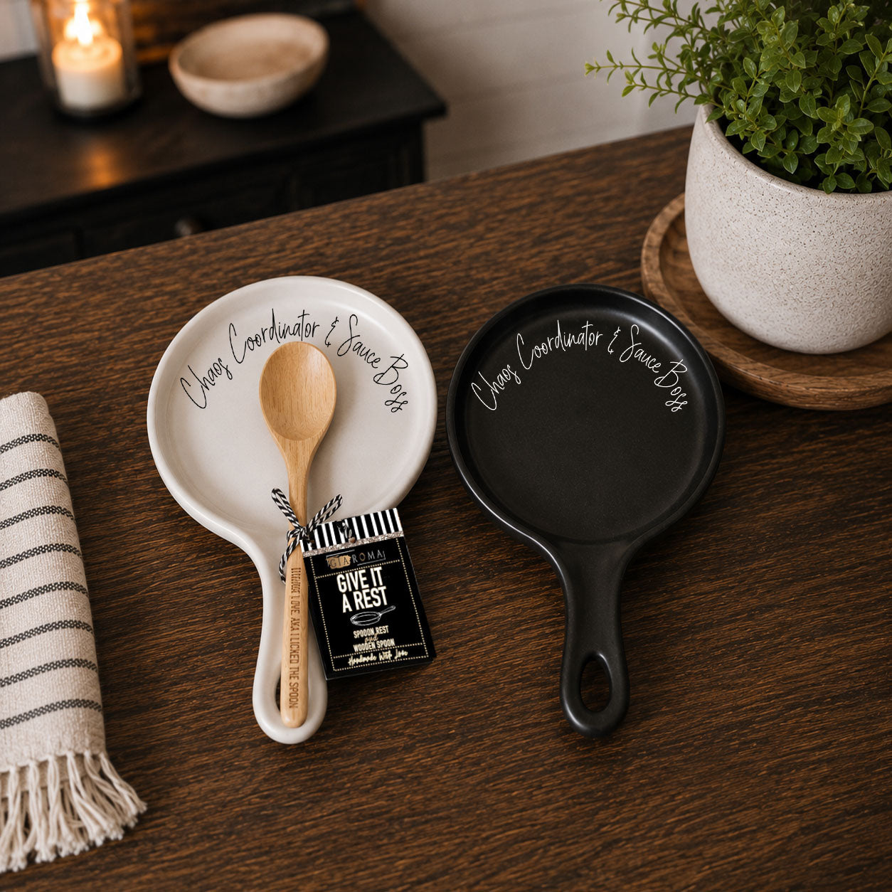 Chaos & Sauce Boss spoon rests 2pk white ceramic and black ceramic with wood spoon Gia Roma on table on Tampa Home & Garden Store