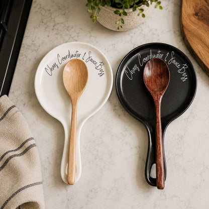 Chaos & Sauce Boss spoon rests in white and black ceramic plates with wooden spoons on Tampa Home & Garden Store