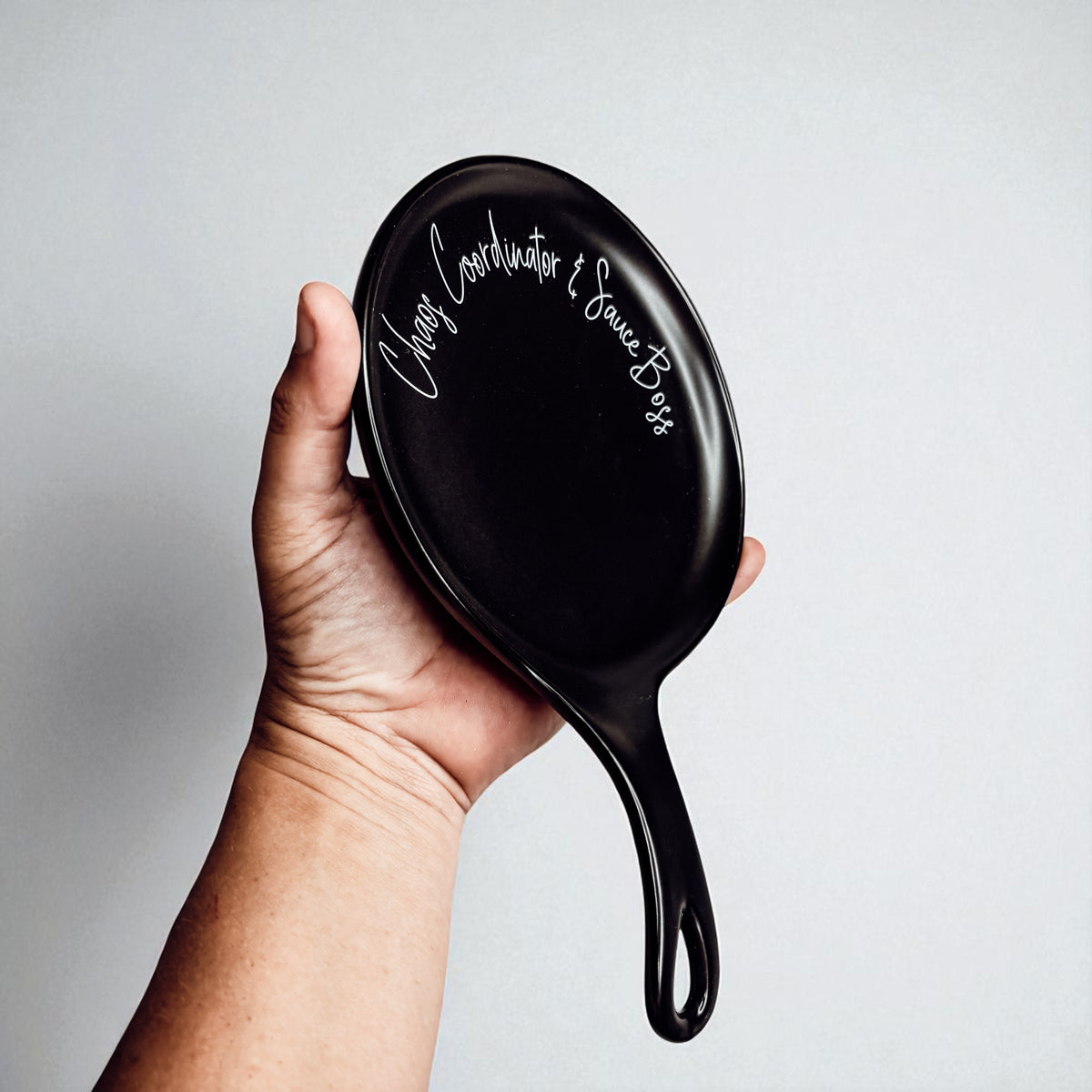 Chaos & Sauce Boss spoon rest, black glossy with white cursive Chaos Coordinator & Sauce Boss text on Tampa Home & Garden Store