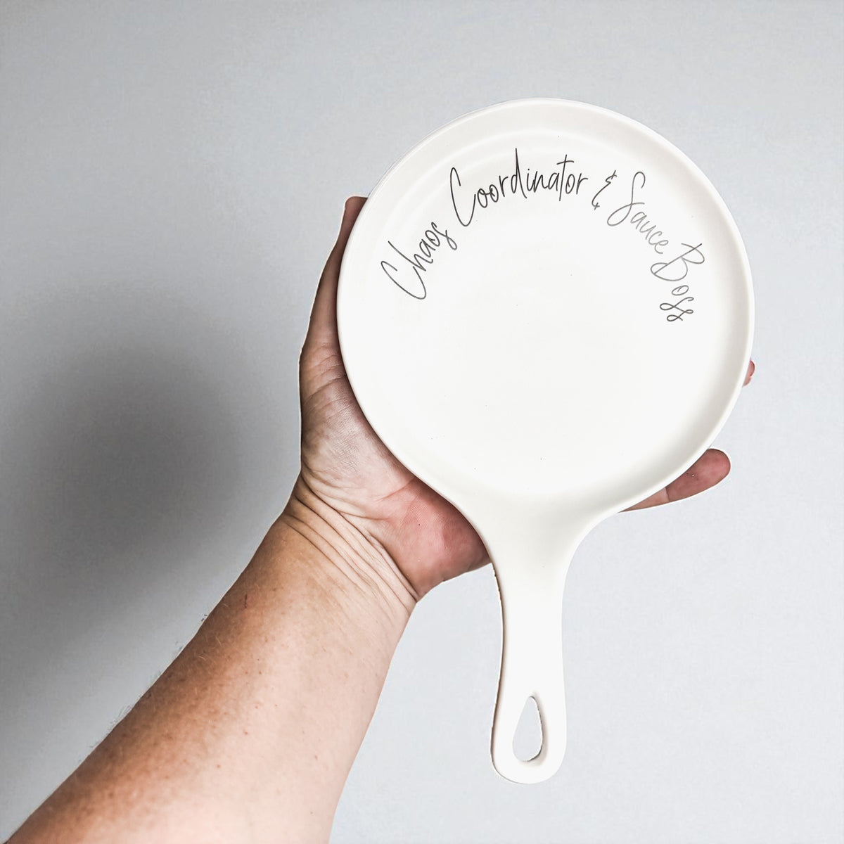 Chaos & Sauce Boss spoon rest by Gia Roma, white ceramic round dish with handle on Tampa Home & Garden Store