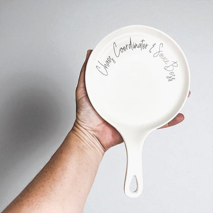 Chaos & Sauce Boss spoon rest by Gia Roma, white ceramic round dish with handle on Tampa Home & Garden Store