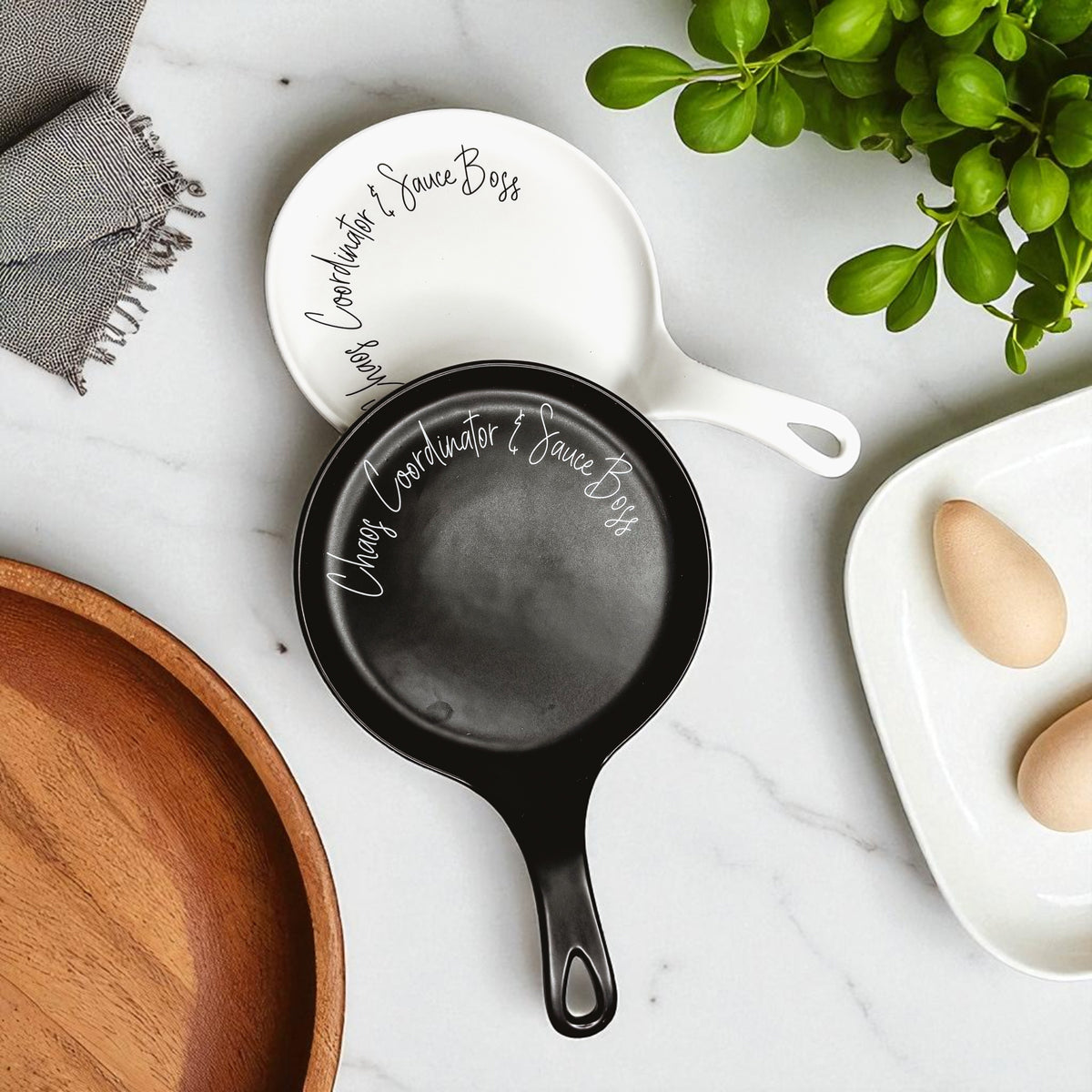 Gia Roma Chaos & Sauce Boss 2pc spoon rests, white and black round pans with script branding on Tampa Home & Garden Store