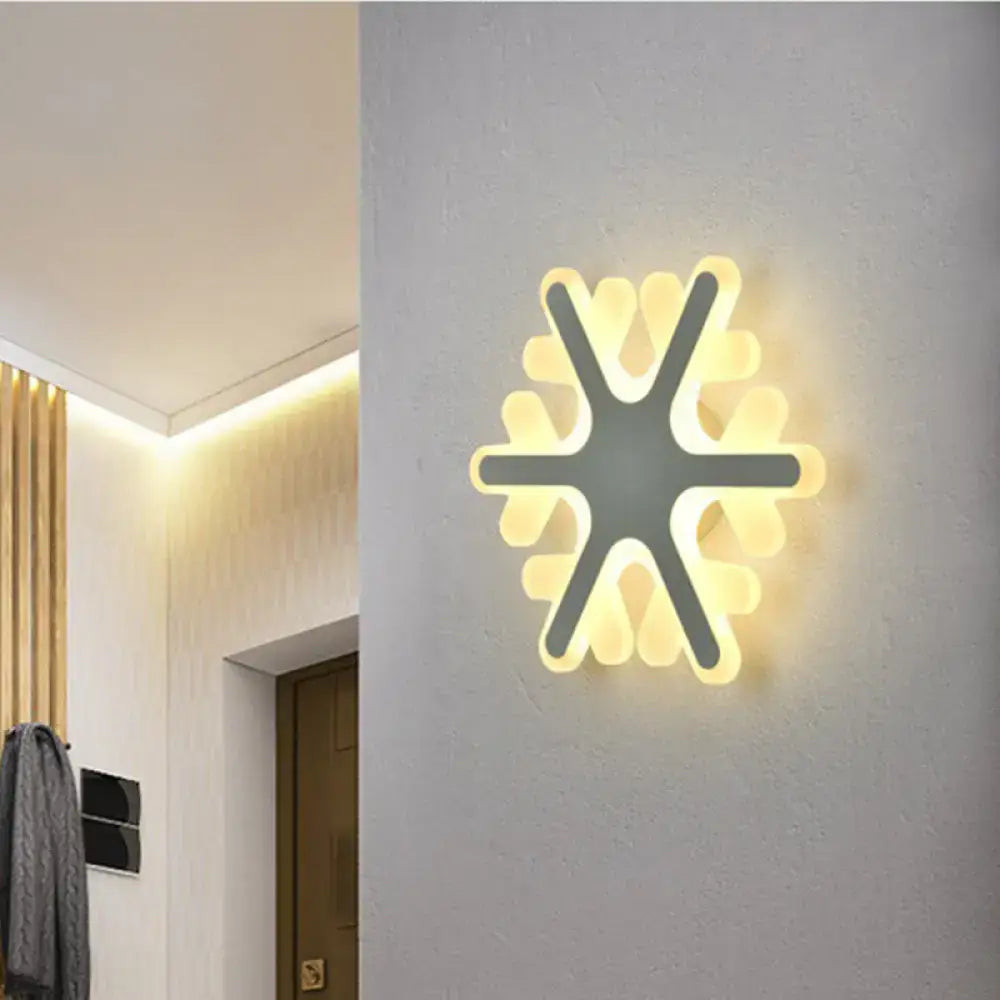 White Sun Wall Sconce by Decorbites, starburst LED light with warm glow on grey wall on Tampa Home & Garden Store