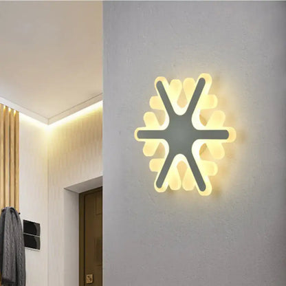 White Sun Wall Sconce by Decorbites, starburst LED light with warm glow on grey wall on Tampa Home & Garden Store